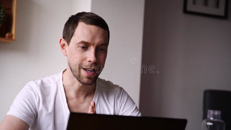 Slow motion video. Young man using laptop. Guy hands typing at computer keyboard