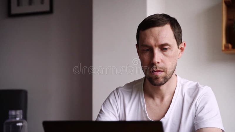 Slow motion video. Young man using laptop. Guy hands typing at computer keyboard