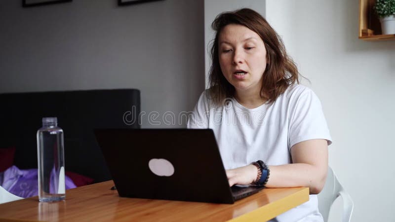 Slow video. Young woman using laptop. Girl hands typing at computer keyboard