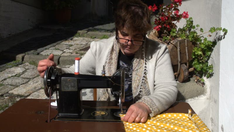 Vintage sewing machine frontal outdoors slow motion MF stock video