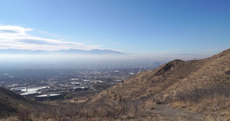 Slow right pan of the Salt Lake City downtown skyline and the entire surrounding area on a clear day