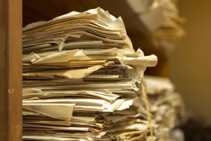 Dusty old stack of papers and files in archive room of office. Dusty old stack of papers and files in archive room of office