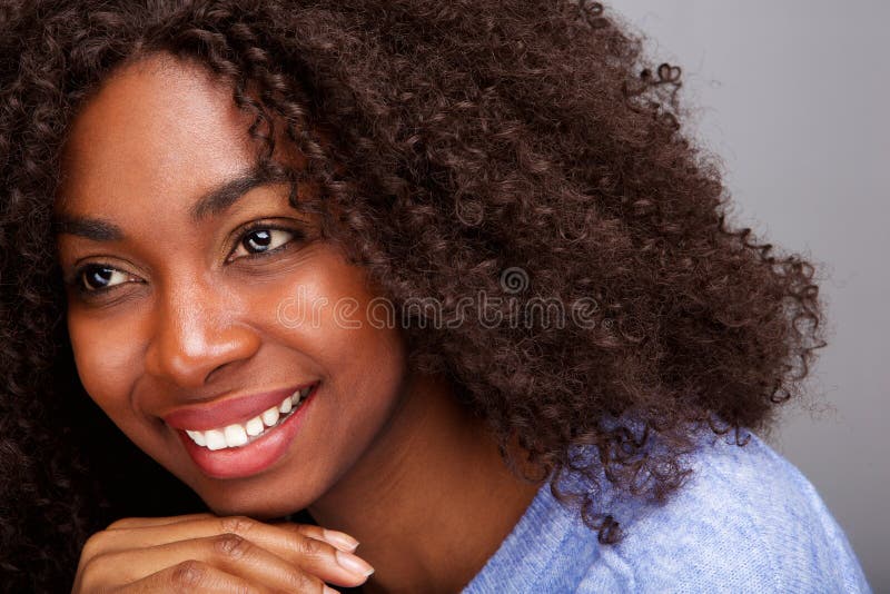 Close up portrait of attractive young african american woman with curly hair looking away. Close up portrait of attractive young african american woman with curly hair looking away