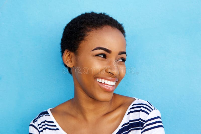 Close up portrait of smiling young black woman looking away. Close up portrait of smiling young black woman looking away