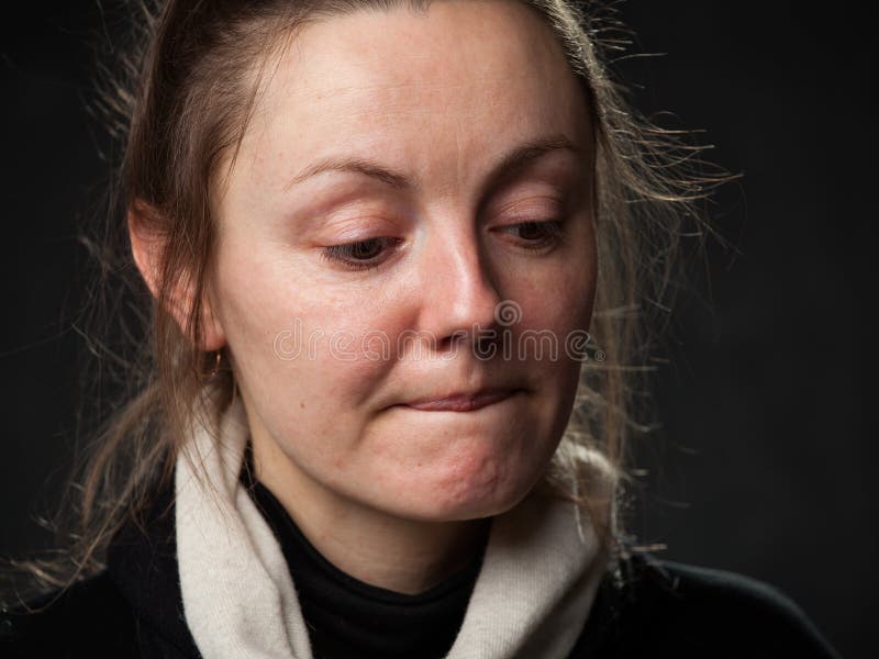 Close up portrait of a young sad disoriented woman , grey background. Close up portrait of a young sad disoriented woman , grey background