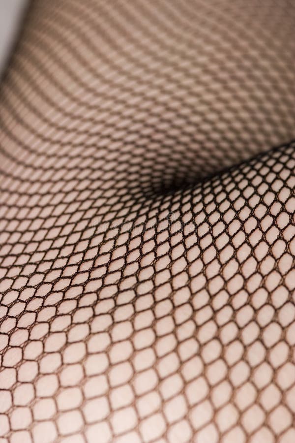 Close up of female leg in black fishnet stockings. Close up of female leg in black fishnet stockings