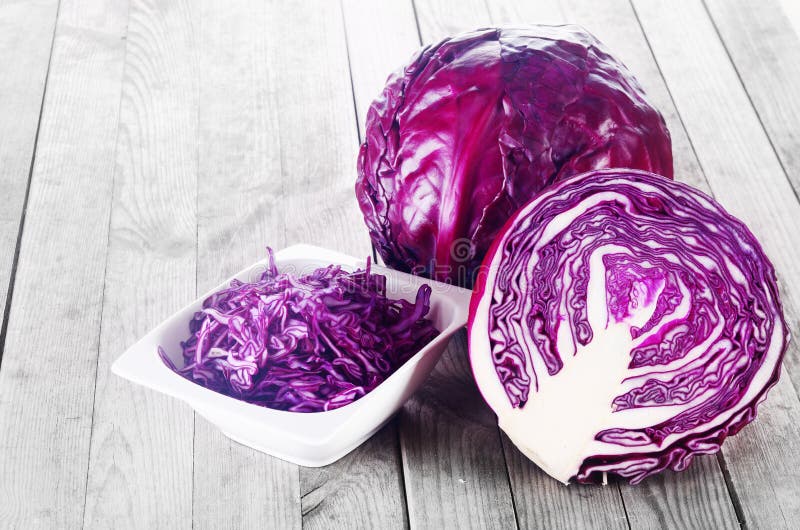 Close up Shredded, Sliced and a Whole of Purple Cabbage Vegetable on Top of Wooden Table. Close up Shredded, Sliced and a Whole of Purple Cabbage Vegetable on Top of Wooden Table
