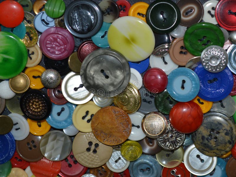 Close up of a panel of multicolored buttons sewn on the fabric. Close up of a panel of multicolored buttons sewn on the fabric