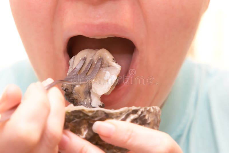 Eating a tasty oyster natural. Eating a tasty oyster natural