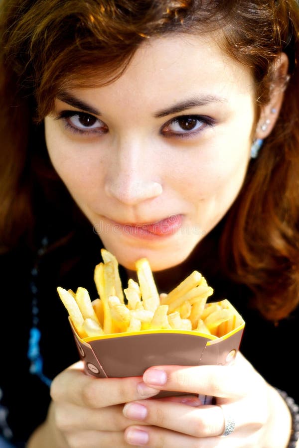 Pretty girl with tasty french fries licking her lips. Pretty girl with tasty french fries licking her lips