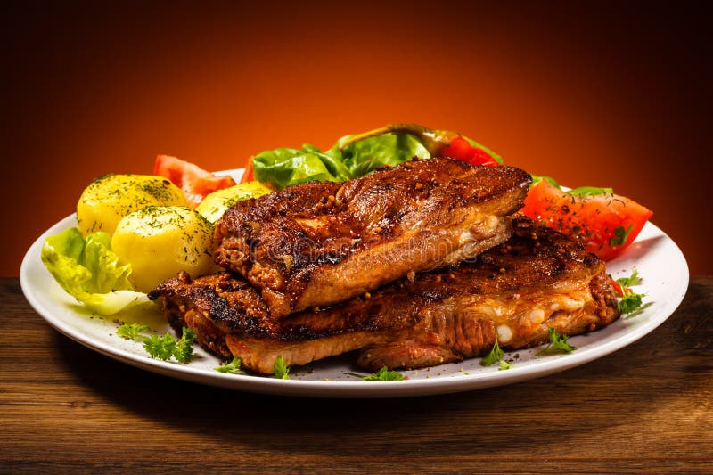 Tasty grilled ribs with vegetables. Tasty grilled ribs with vegetables