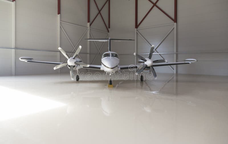 Small aircraft parked in a hangar