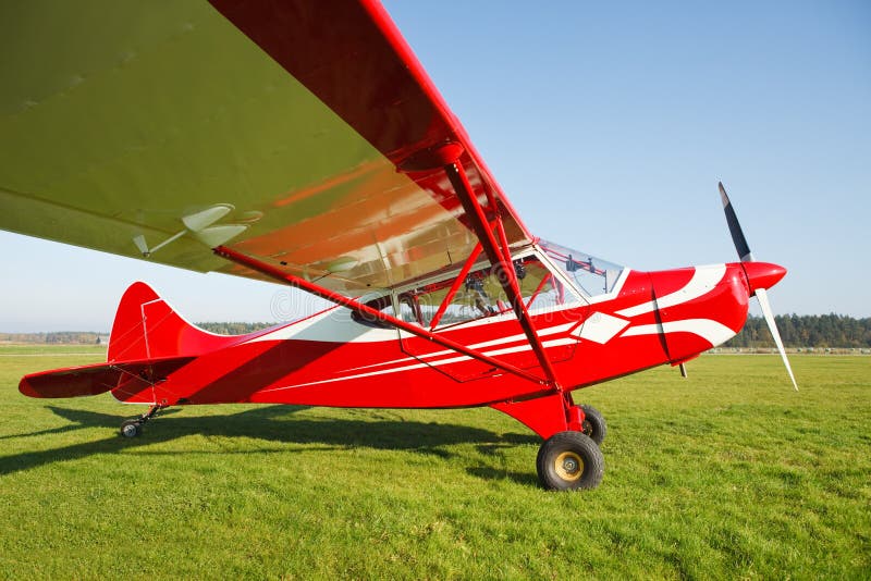 Small airplane on airfield grass royalty free stock photography