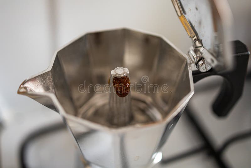 Small Aluminum Coffee Maker with Flowing Up Black Coffee Stock Photo