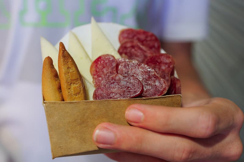 Small Appetizer To Eat Quickly in a Paper Container with Cheese, Salami