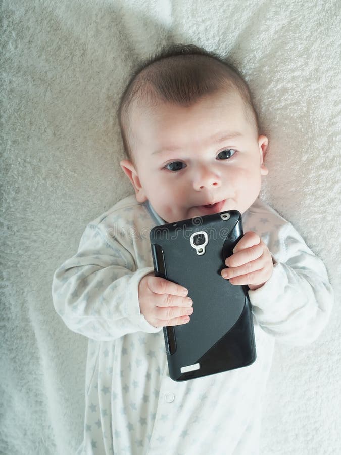 Small Baby Boy Holding Smartphone in Bed Stock Photo Image of black