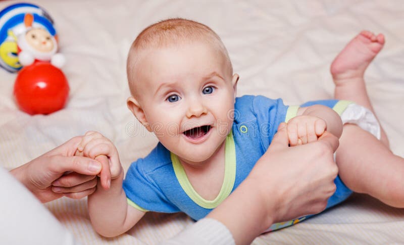 Small baby holding mother s hands