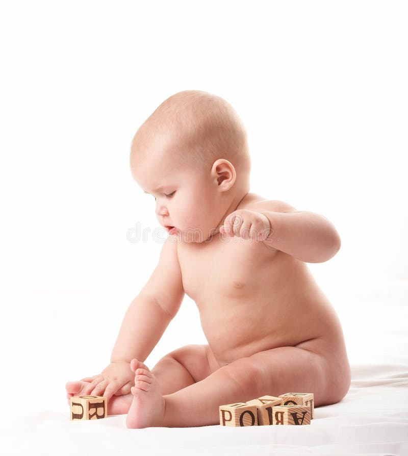 Small baby playing with blocks after taking a bath 2