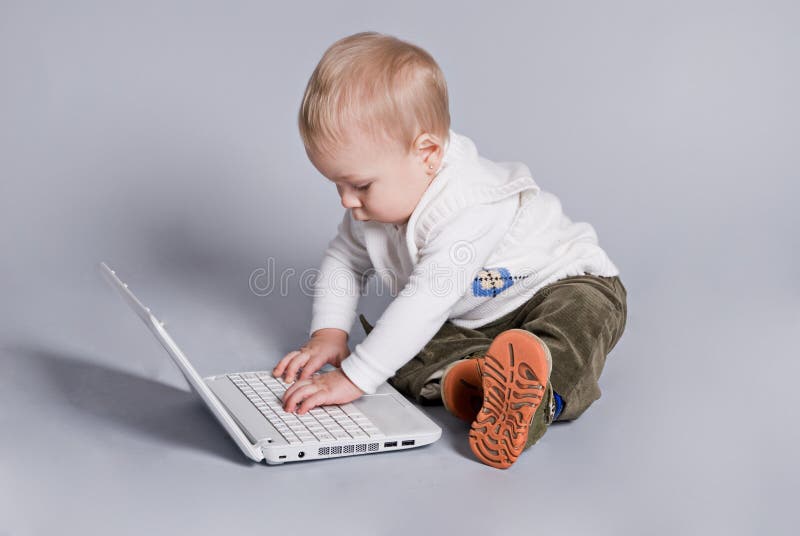 Small baby with white laptop