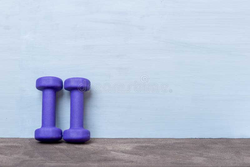 Small Blue Dumbbells on Wooden Surface Stock Photo - Image of online ...