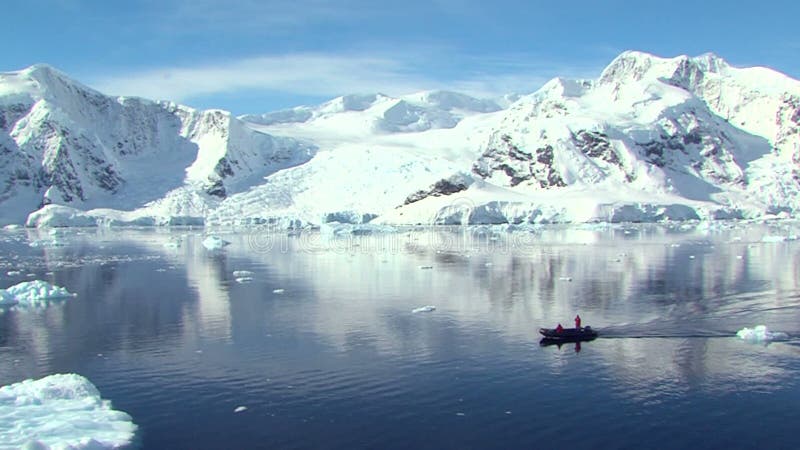 Small boat in antarctica stock video footage