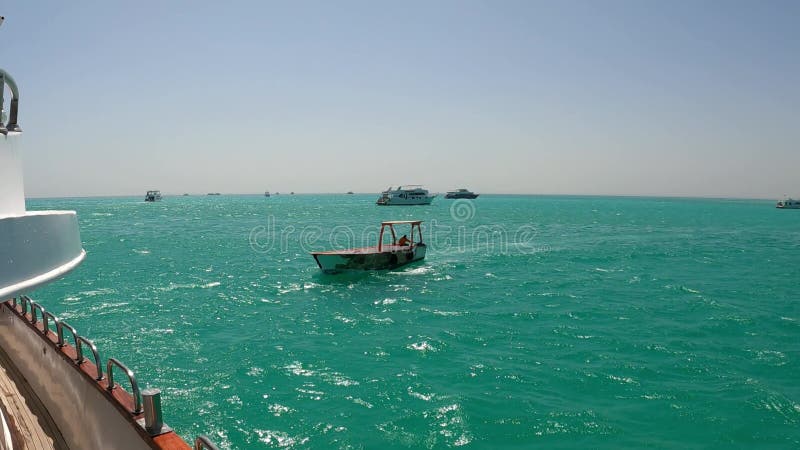 Small boat navigating turquoise ocean waters stock video footage