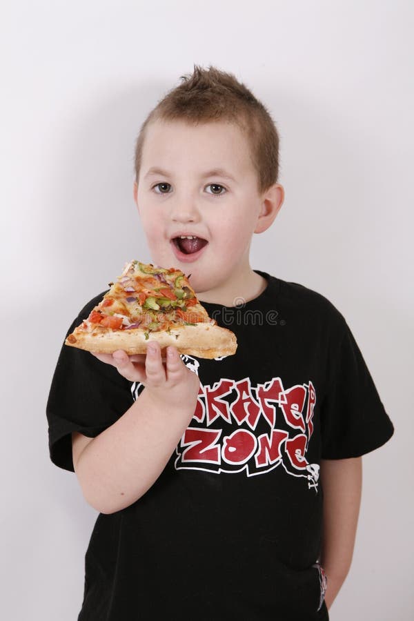 Small boy eating pizza slice