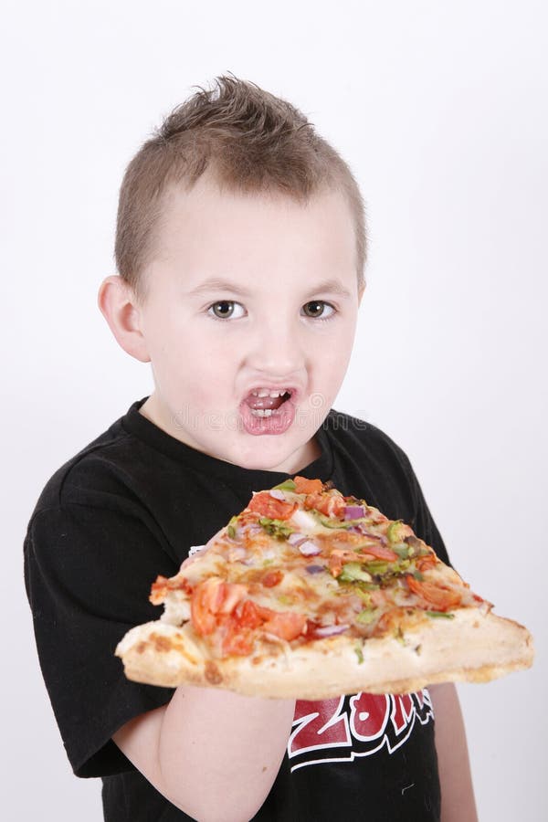 Small boy eating pizza slice