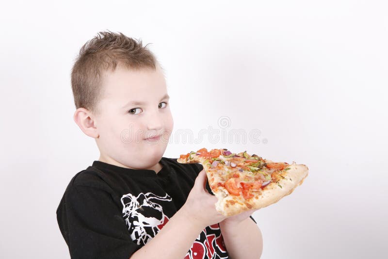 Small boy eating pizza slice