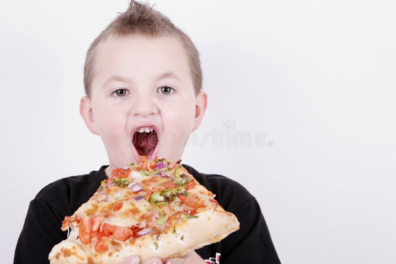 Small boy eating pizza slice