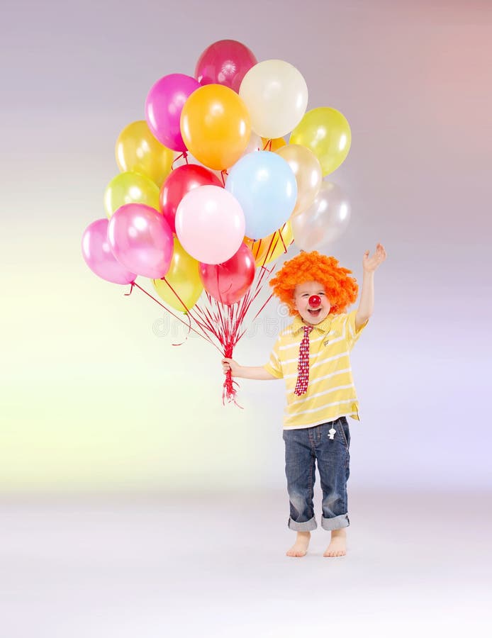 Small boy holding bunch of balloons royalty free stock photo Small boy holding bunch of balloons royalty free stock photo