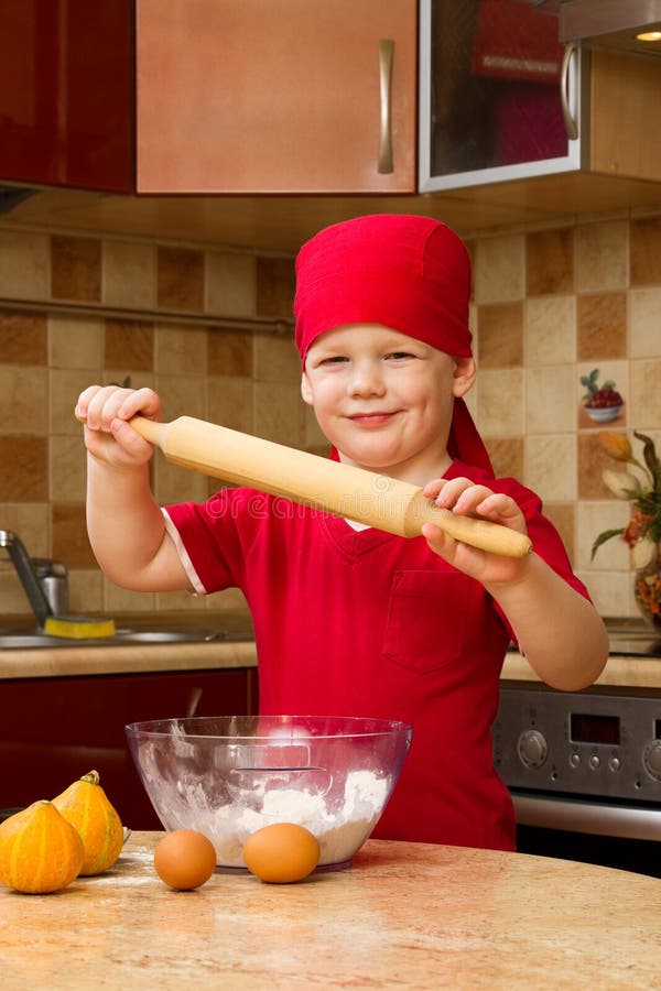 Small boy in kitchen with baking pie