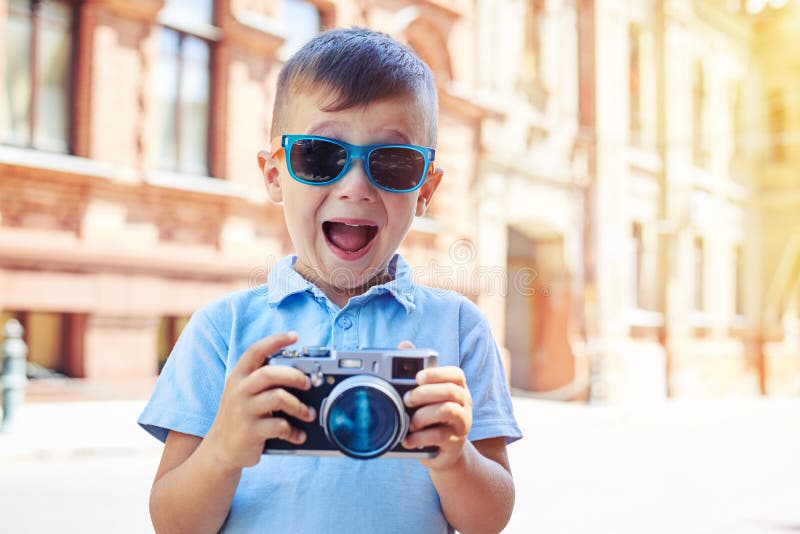 Small boy is making excited face trying to take a shot in the ci