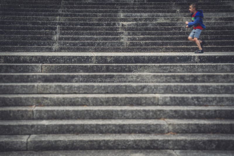 Small Boy Running Across Concrete Stairs Stock Photo - Image of shoes ...