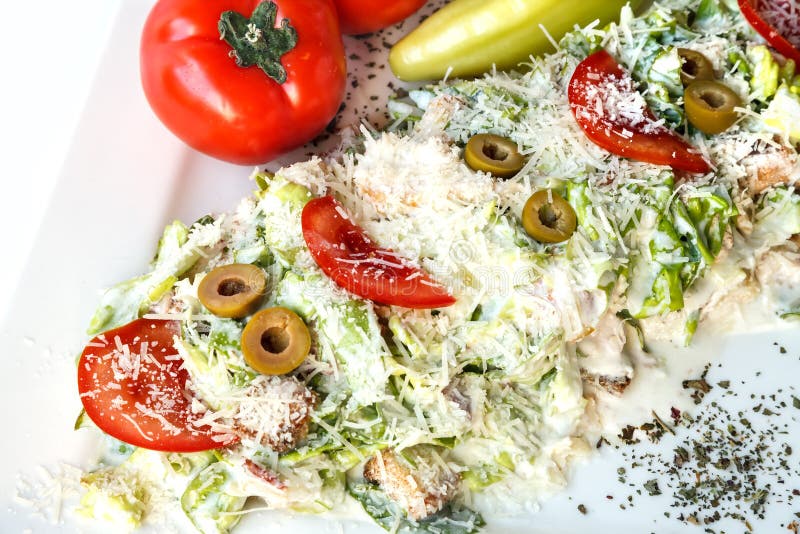 A Small Caesar Salad with Shredded Parmesan Cheese, Croutons and Stock