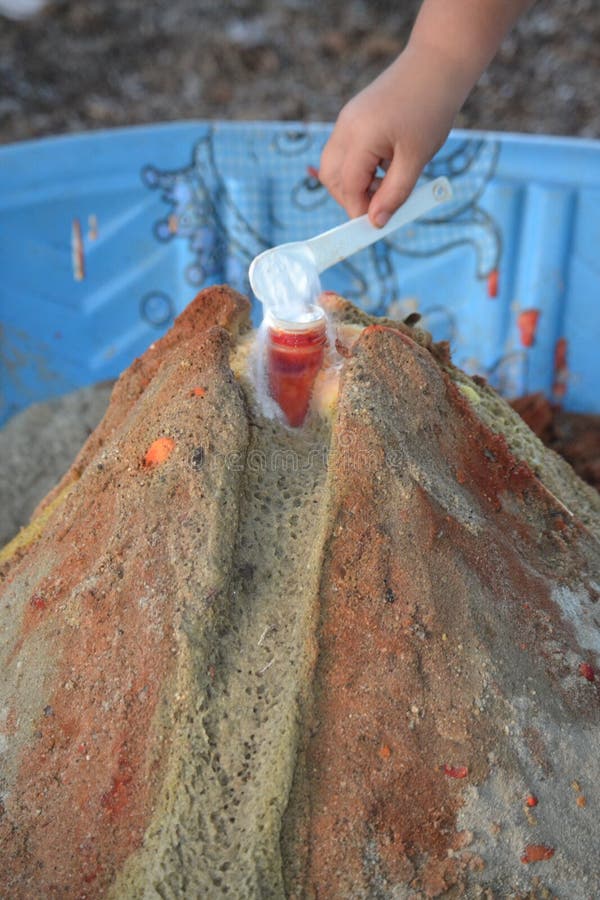 A small child adding to a science experiment. stock images