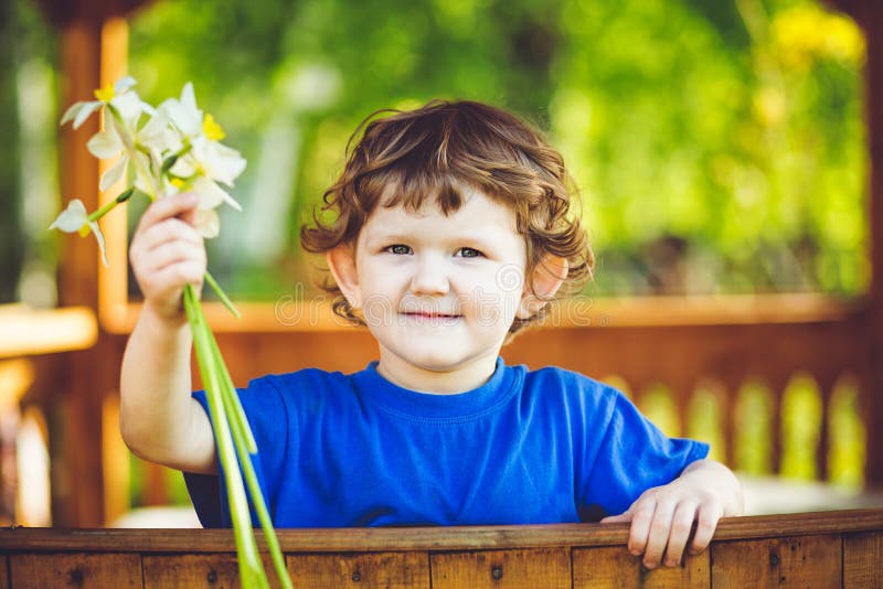 Small child with a flower in her hand. stock photo