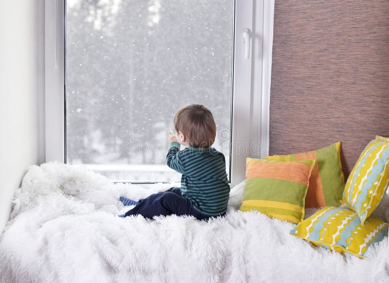 Small child looking out the window royalty free stock images Small child looking out the window royalty free stock images