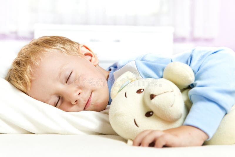 Small child sleeping in bed stock photos Small child sleeping in bed stock photos