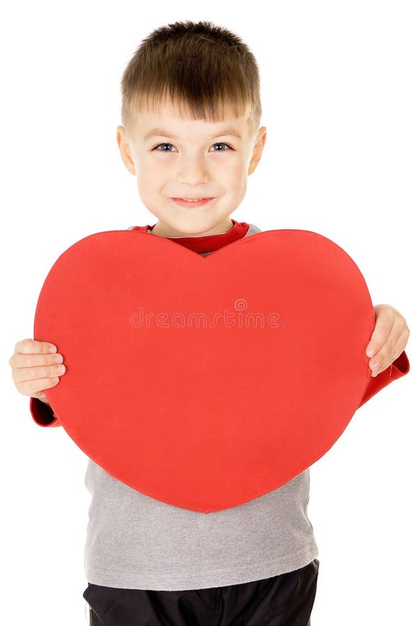 A small child stands and holds the heart