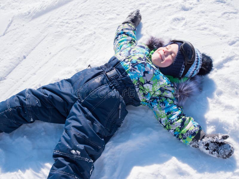 A small child walks in the winter Park. Playing and smiling baby on white fluffy snow. Active rest and games. stock photos A small child walks in the winter Park. Playing and smiling baby on white fluffy snow. Active rest and games. stock photos