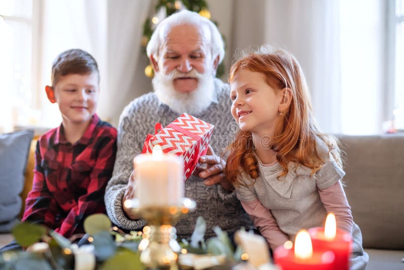 Small Children with Senior Grandfather Indoors at Home at Christmas ...