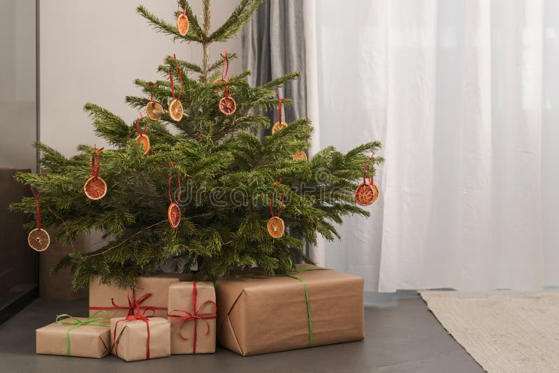 Small Christmas Tree with Natural Decorations and Gift Boxes Stock