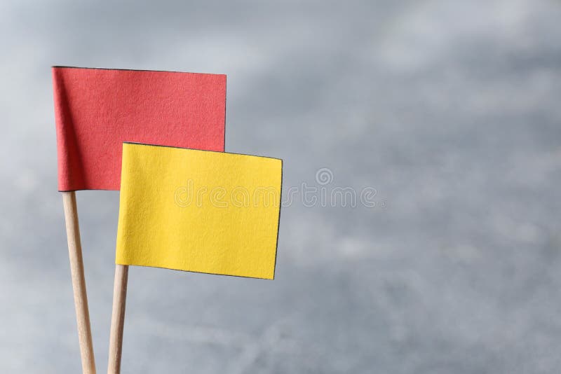 Small color paper flags on blurred background, closeup. Space for text royalty free stock images
