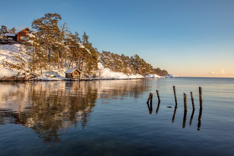 Small cottage by sea on a winter day royalty free stock photo