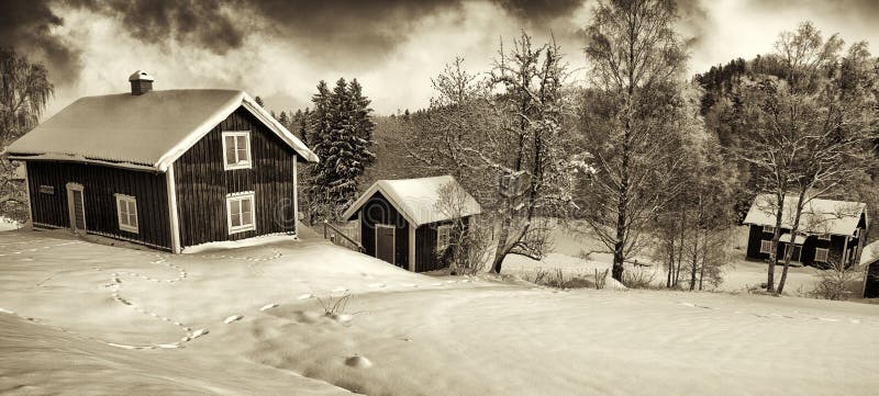 Small cottages in old rural winter landscape