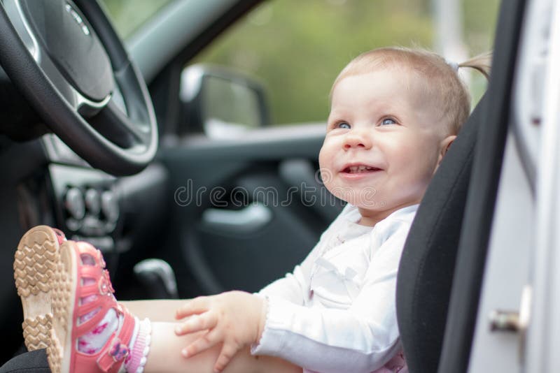 Small cute baby in a car stock image. Image of small 79957079