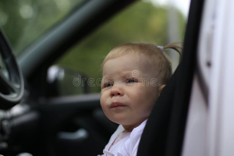 Small cute baby in a car stock photo. Image of driving 79957164