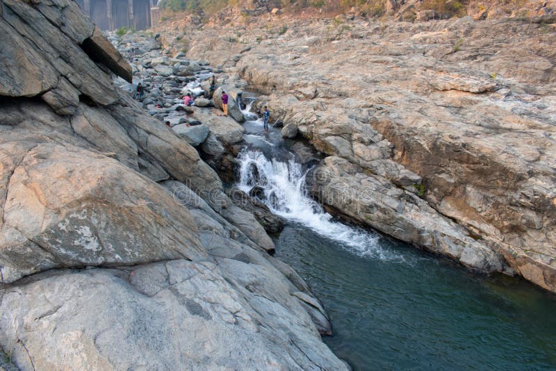 A small dam area where water is falling between the rocks