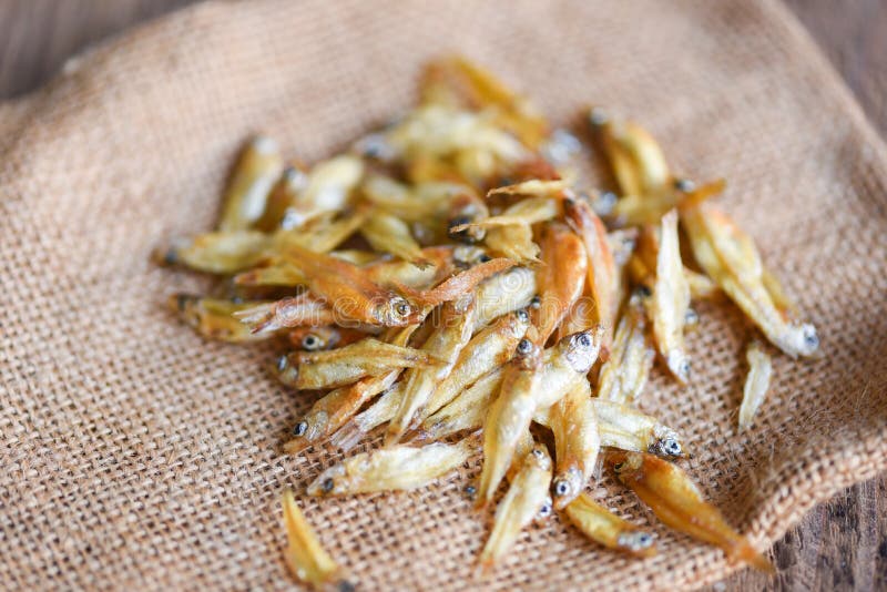 Small Dried Fish on the Sack Background, Crispy Fish for Snack Stock
